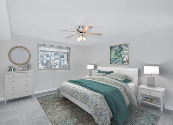 a bedroom with a bed and a ceiling fan