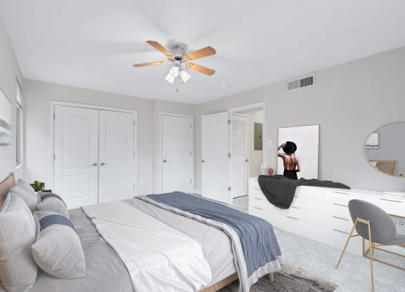 a bedroom with white walls and a white bed with gray pillows