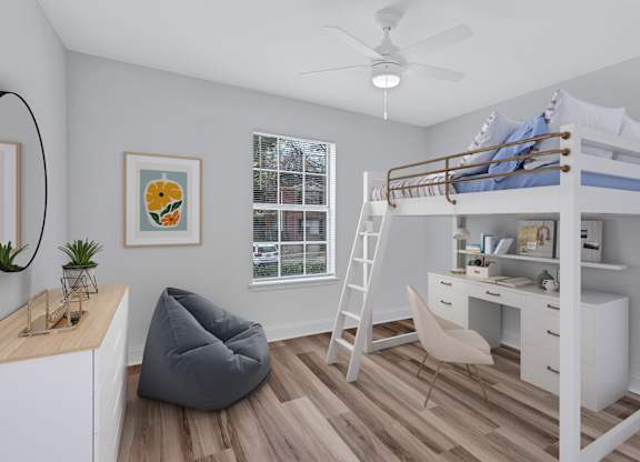 A room with a bunk bed, desk, chair, and a hanging chair.