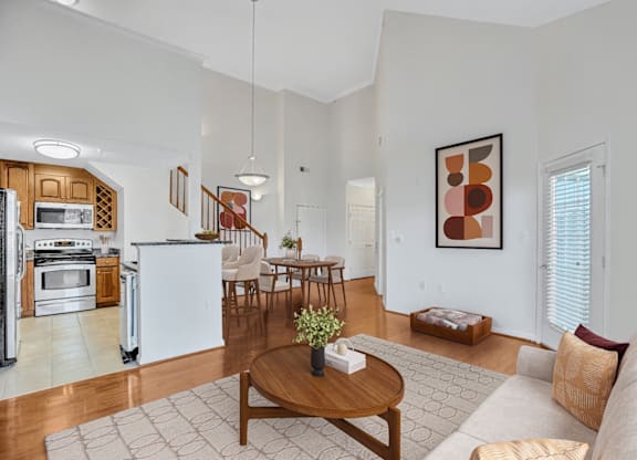 A modern kitchen with a dining table and chairs.