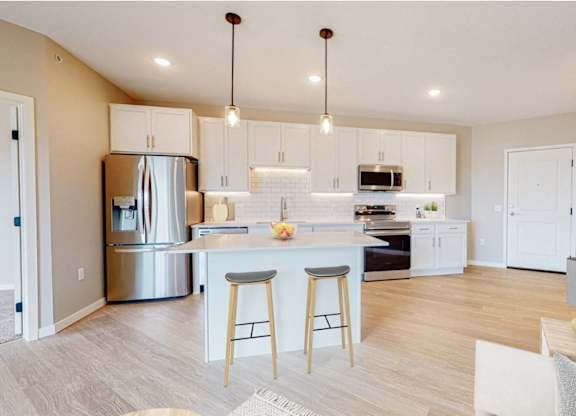 A modern kitchen with a bar area and a dining area.