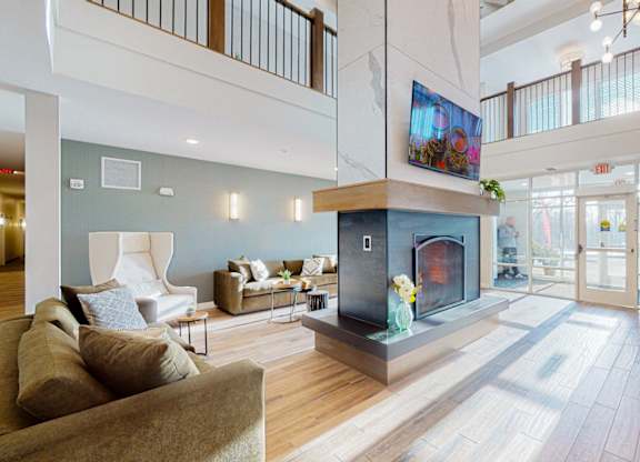 A living room with a fireplace and a television.