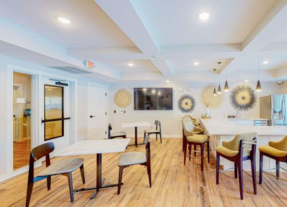 A dining room with a white table and chairs.
