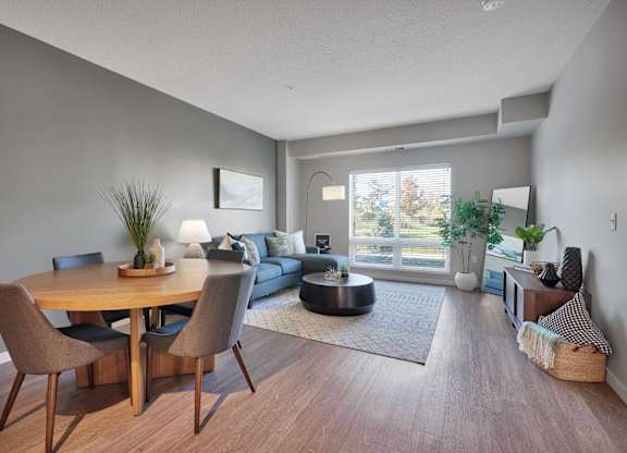A modern dining room with a wooden table and chairs.