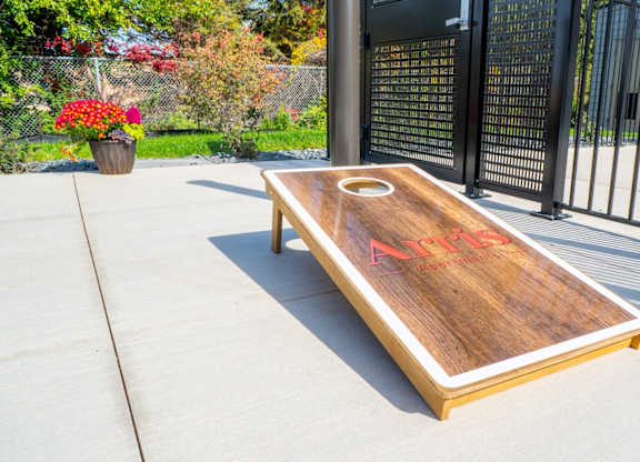 A shuffleboard table with red letters on it.