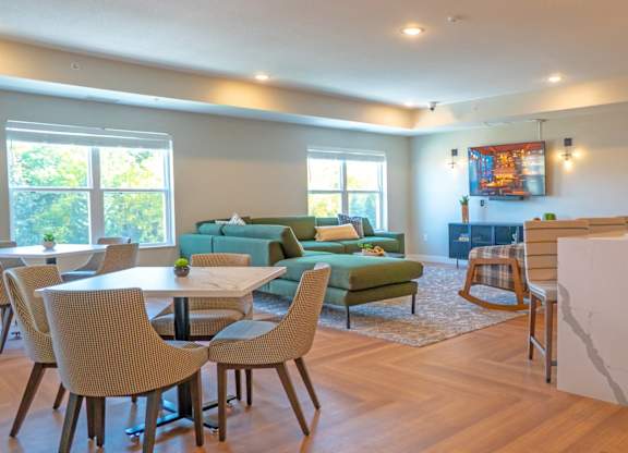 A modern living room with a dining table and chairs.