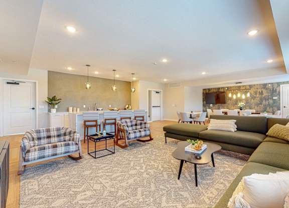 A living room with a couch, chairs, and a coffee table.