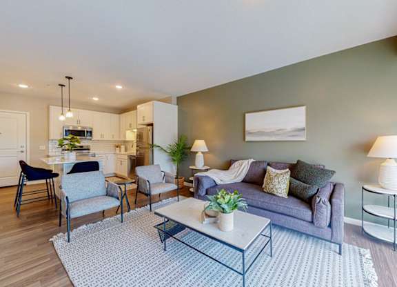 A modern living room with a grey couch and a coffee table.