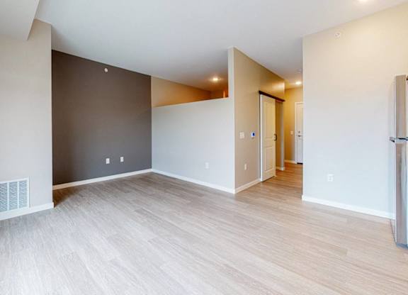 A room with a white ceiling and a wooden floor.