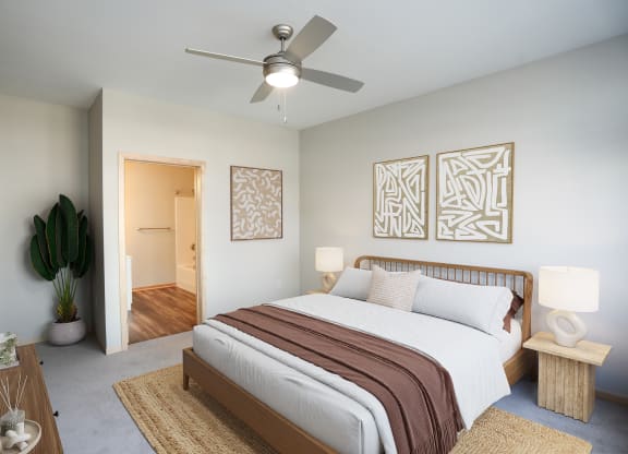 a bedroom with a large bed and a ceiling fan