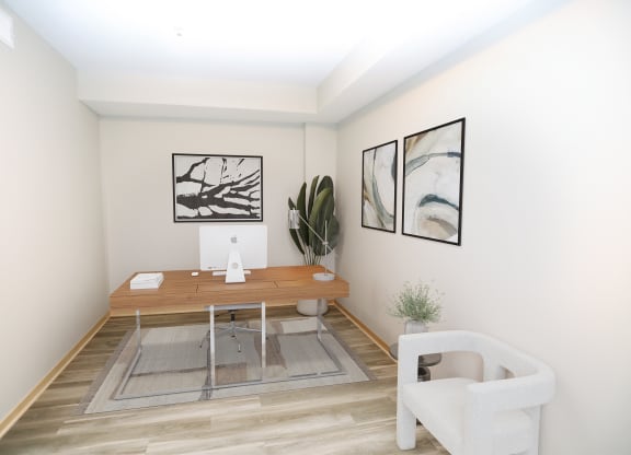 a small room with a wooden desk and a chair
