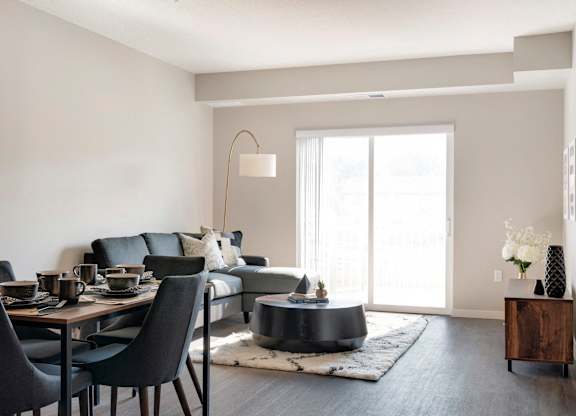 A modern dining room with a black table and chairs.