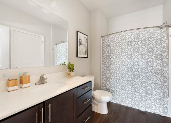 A bathroom with a white sink and a toilet.
