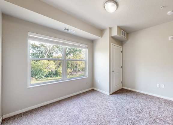 A room with a window and a door.
