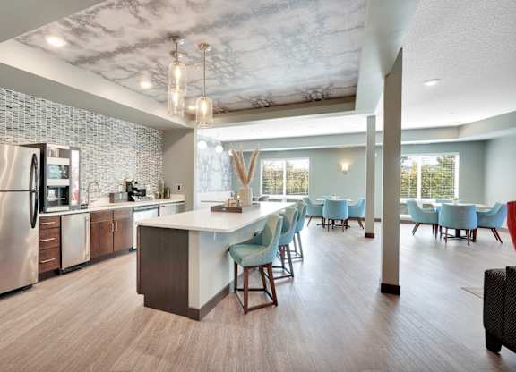 A modern kitchen with a dining area and a refrigerator.