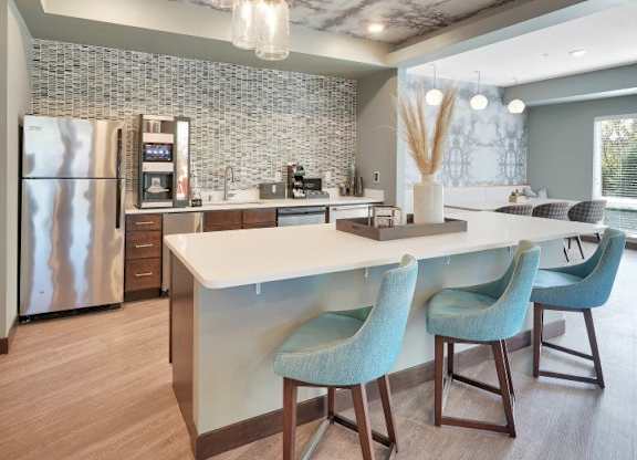A modern kitchen with a marble ceiling and a central island.