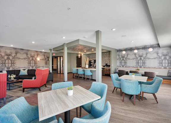A dining room with blue chairs and a wooden table.