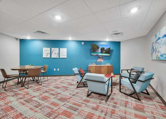 A room with a blue wall and a carpet with a red and beige pattern.
