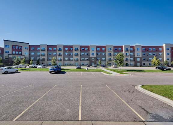 A parking lot with a building in the background.