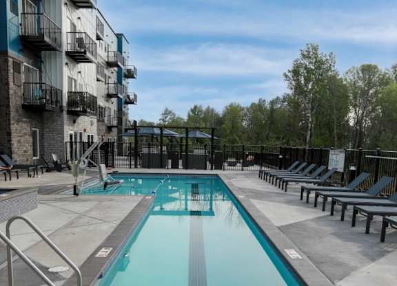 A long rectangular pool with a metal ladder on the side.