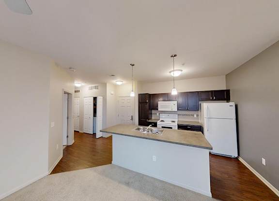the interior of a room with white walls and wooden floors