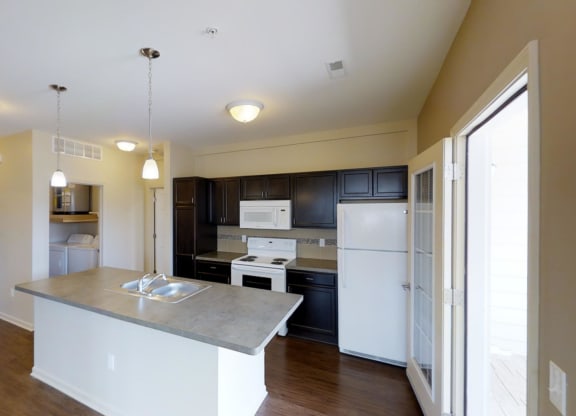a kitchen with white appliances and black cabinets