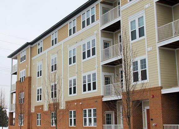 a large apartment building with brick and yellow siding