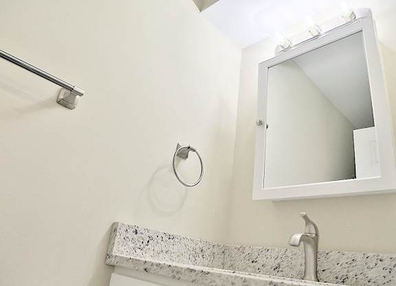A bathroom sink with a mirror above it.