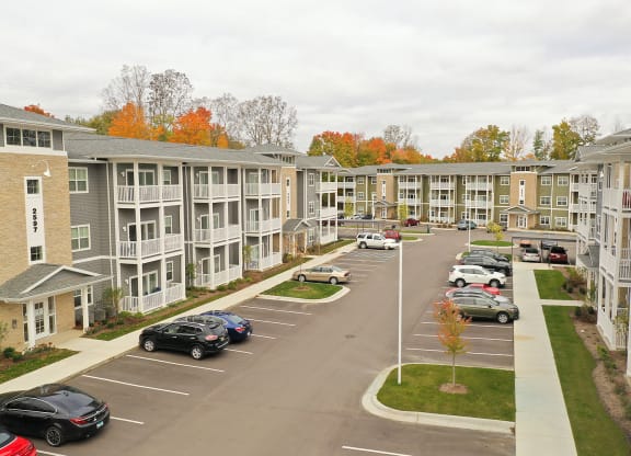 a view of a parking lot in front of an apartment complex