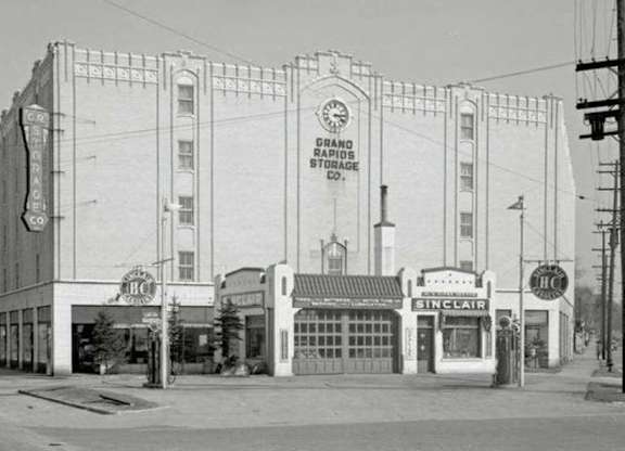 an old photo of a theater on a city street