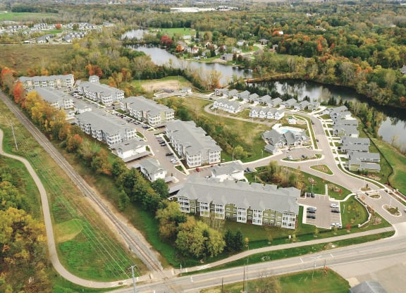 an aerial view of a city with a river and buildings