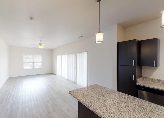 the spacious living room and dining room of an apartment