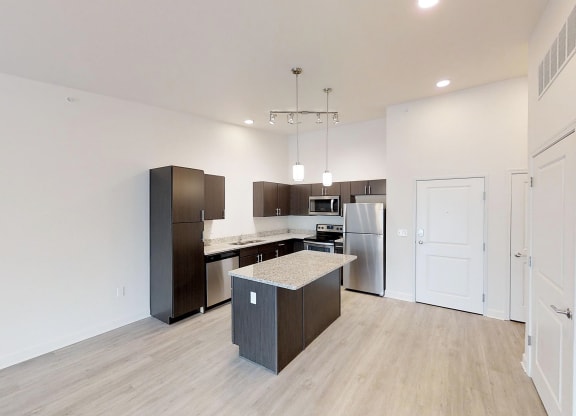 a renovated kitchen with a island and stainless steel appliances