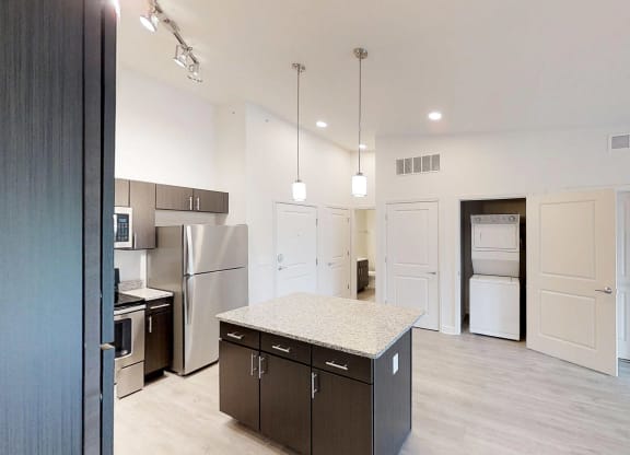 a kitchen with stainless steel appliances and a granite counter top