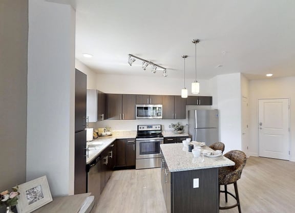 a kitchen with stainless steel appliances and a counter top