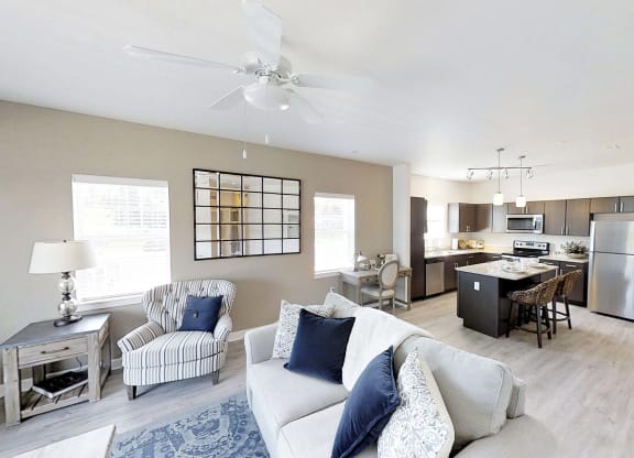 a living room with a couch and a kitchen