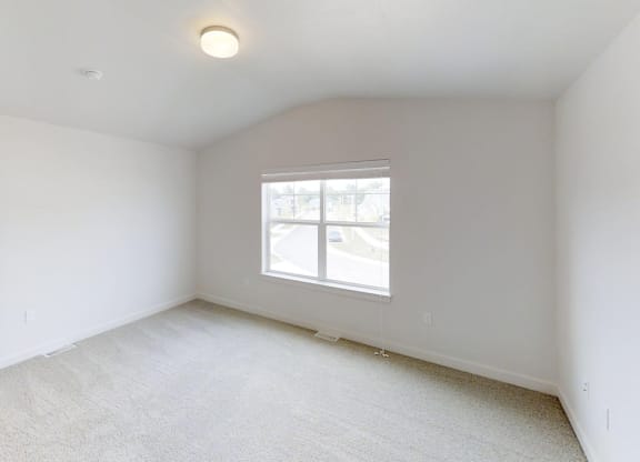 a bedroom with a window and a door