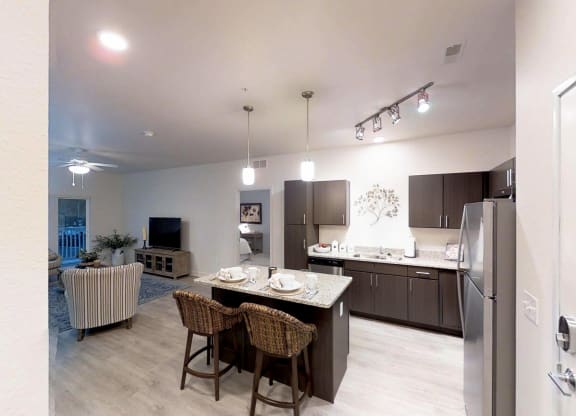 a kitchen and living room with a table and chairs