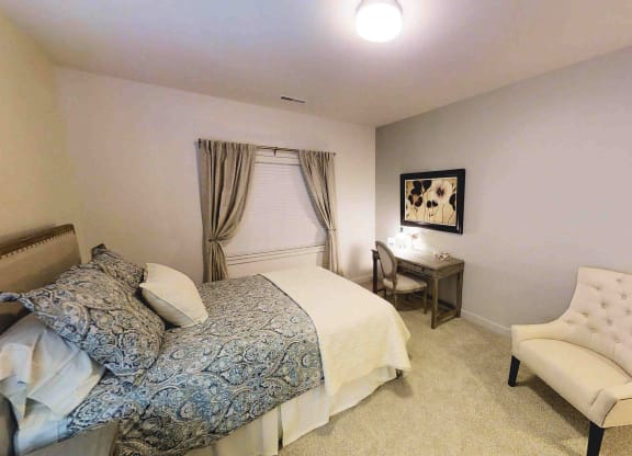 a bedroom with a bed and a chair