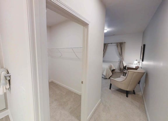 a bedroom with a closet and a closet door open to a room with a bed