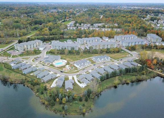an aerial view of an apartment complex with a body of water