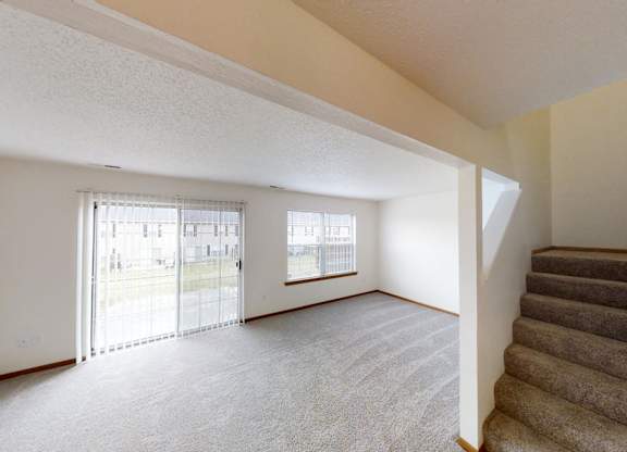 A room with a staircase leading to the second floor.
