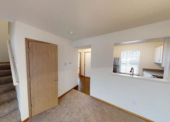A room with a staircase and a window.