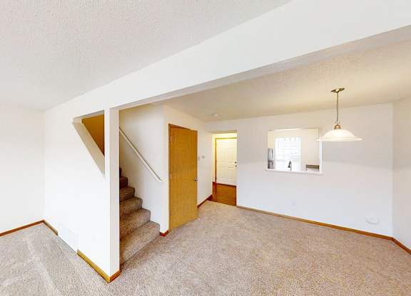A room with a staircase and a small window.