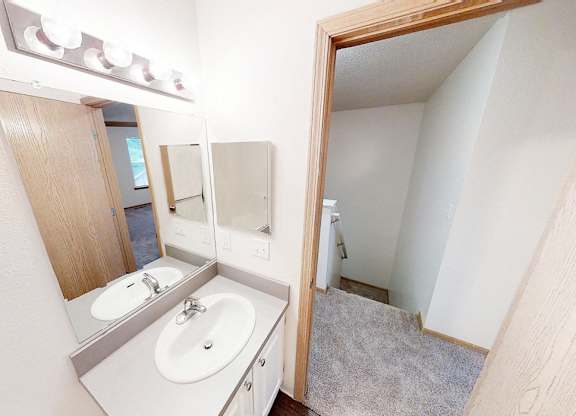 A bathroom with a sink and mirror.