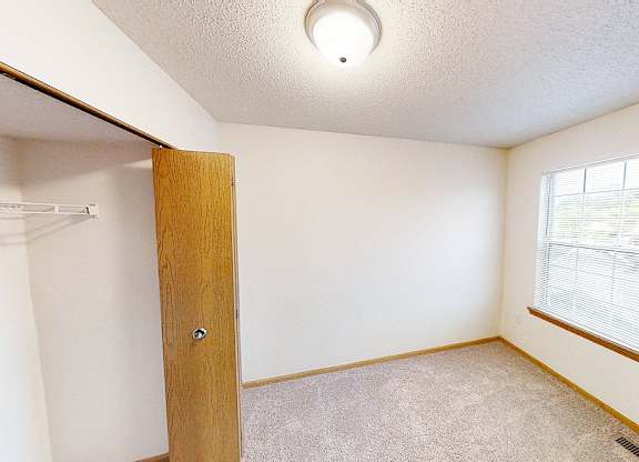 A room with a door and a window.