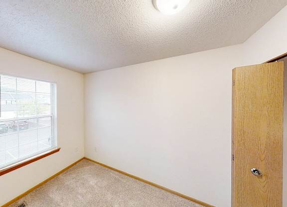 A room with a window and a door.