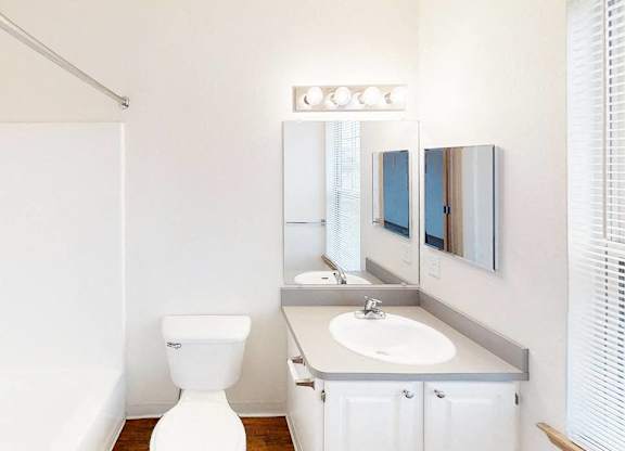 A white toilet sits next to a sink in a bathroom.