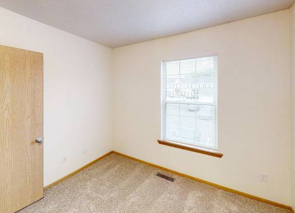 A room with a door and a window.