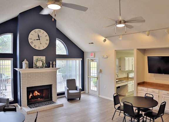 Clubhouse with a fireplace and a large clock on the wall